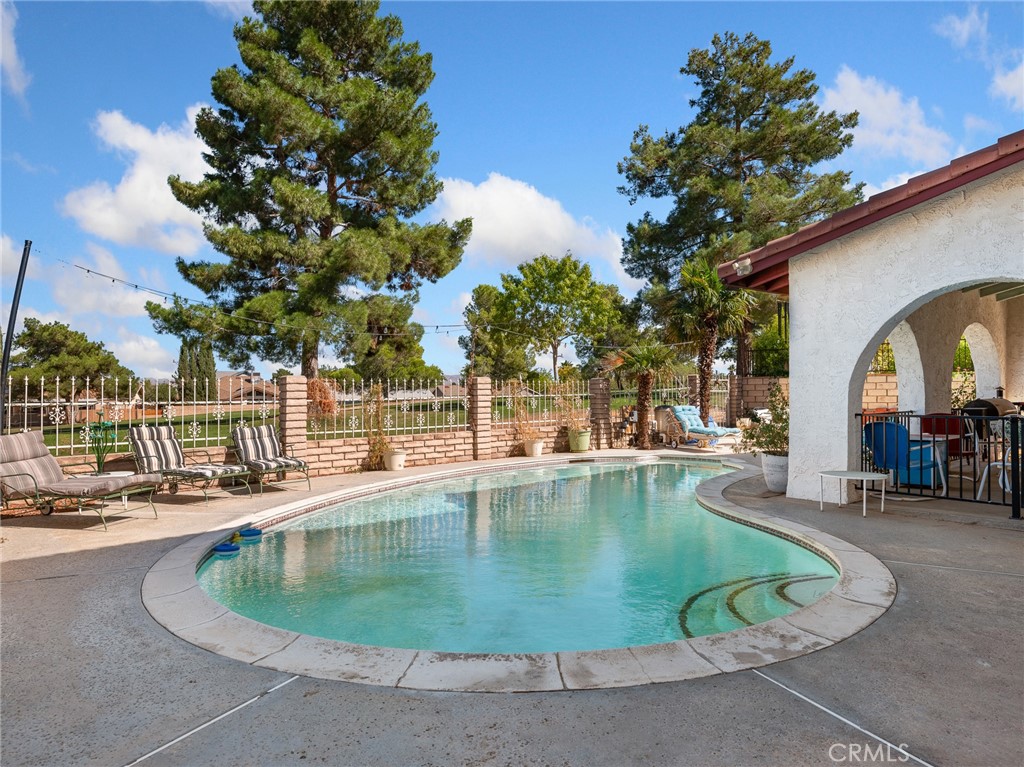 13916 Burning Tree Drive Victorville, CA 92395 - Photo 44 of 49 a view of a swimming pool with a patio