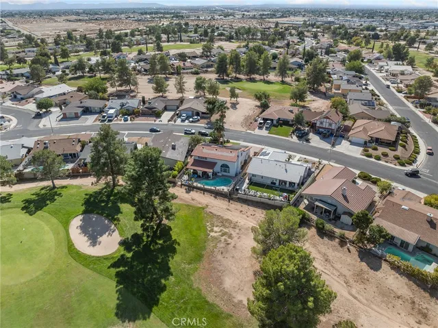 an aerial view of a house with a swimming pool yard and outdoor seating