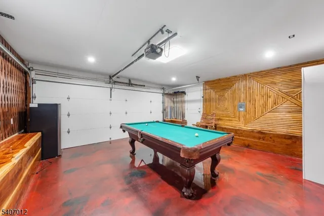 a room with pool table and windows