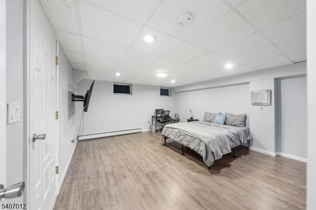 a spacious bedroom with a bed and a wooden floor