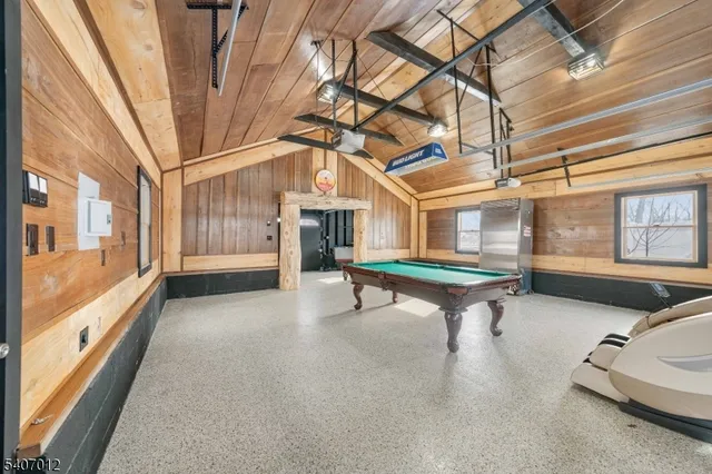 a room with pool table and windows