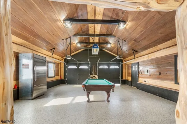 a room with lots of wooden cabinets and stainless steel appliances