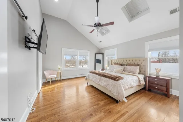 a bedroom with a large bed and a chandelier
