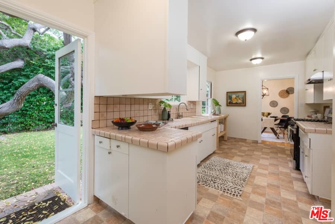 5712 Tellefson Road Culver City, CA 90230 - Photo 11 of 25 a kitchen with sink cabinets and outdoor view