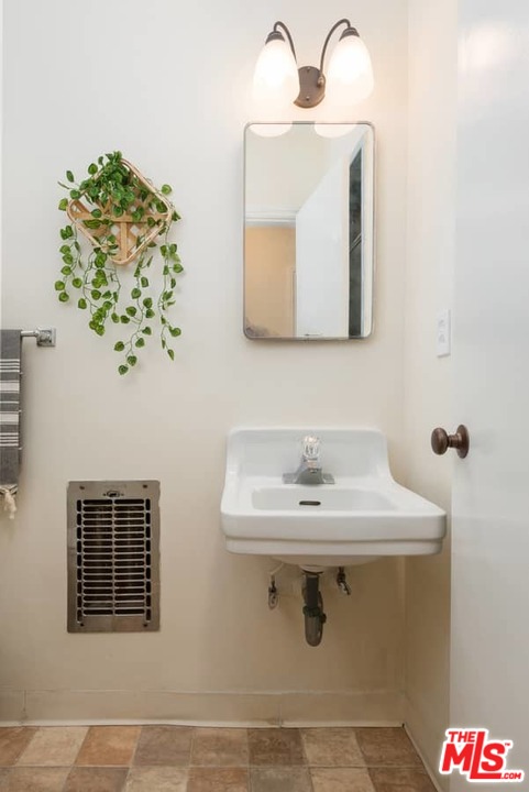 5712 Tellefson Road Culver City, CA 90230 - Photo 13 of 25 a bathroom with a sink and a mirror