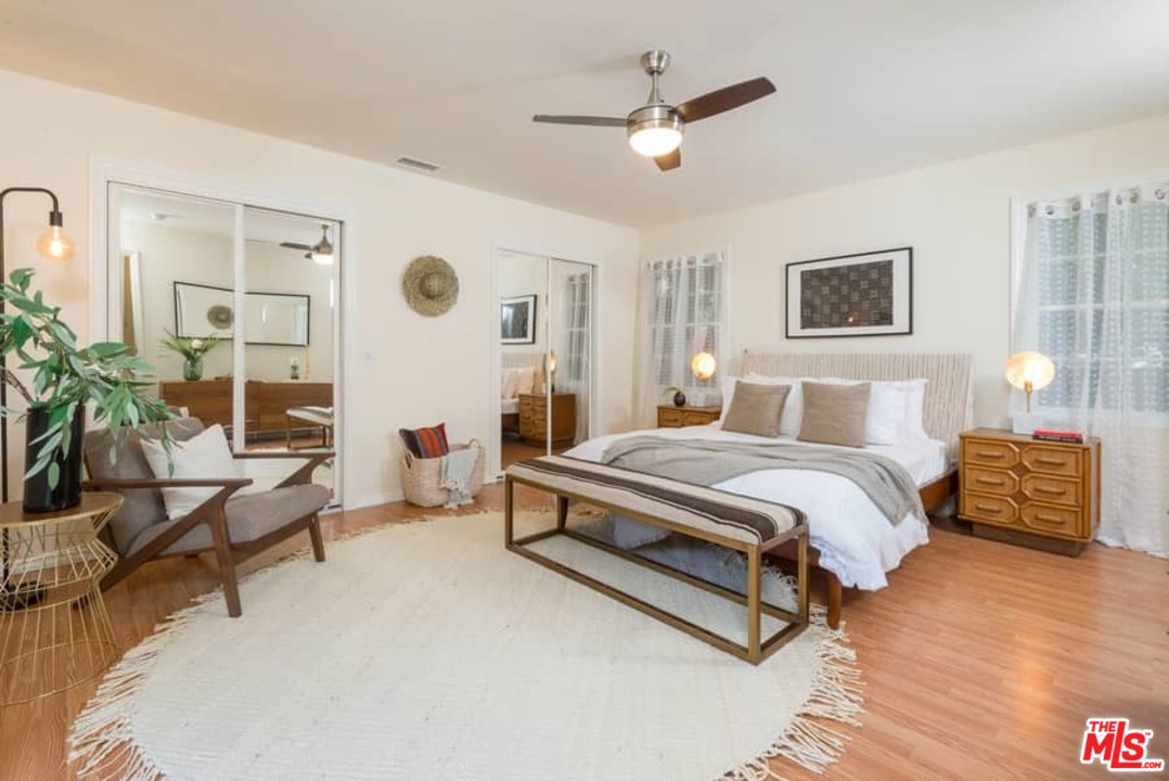 5712 Tellefson Road Culver City, CA 90230 - Photo 14 of 25 a spacious bedroom with a bed a couch and potted plant
