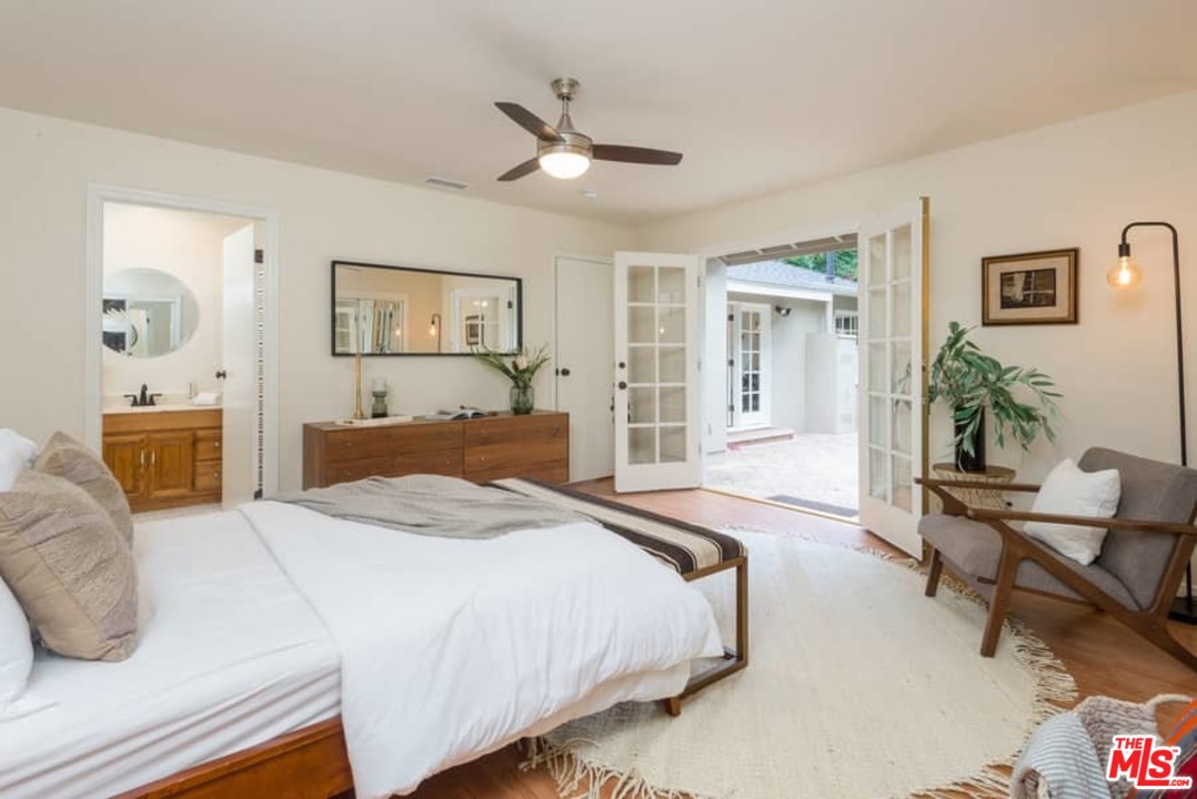 5712 Tellefson Road Culver City, CA 90230 - Photo 16 of 25 a bedroom with a bed and wooden floor