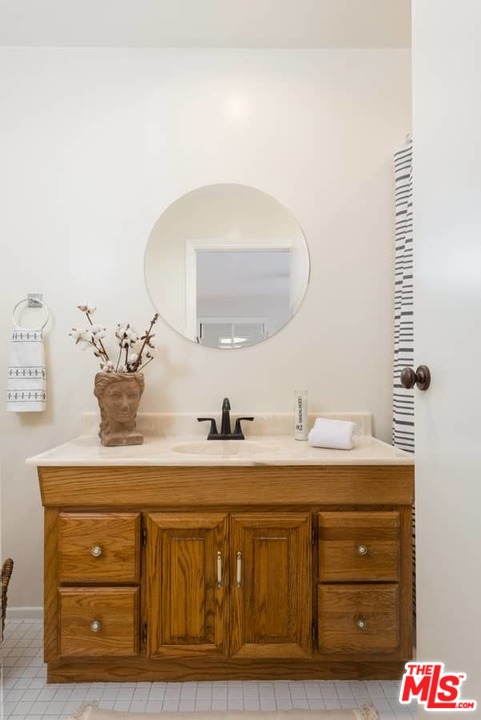 5712 Tellefson Road Culver City, CA 90230 - Photo 17 of 25 a bathroom with a sink and a mirror