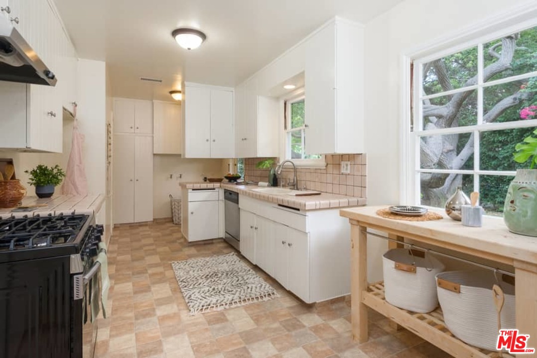 5712 Tellefson Road Culver City, CA 90230 - Photo 9 of 25 a kitchen with a stove sink and cabinets