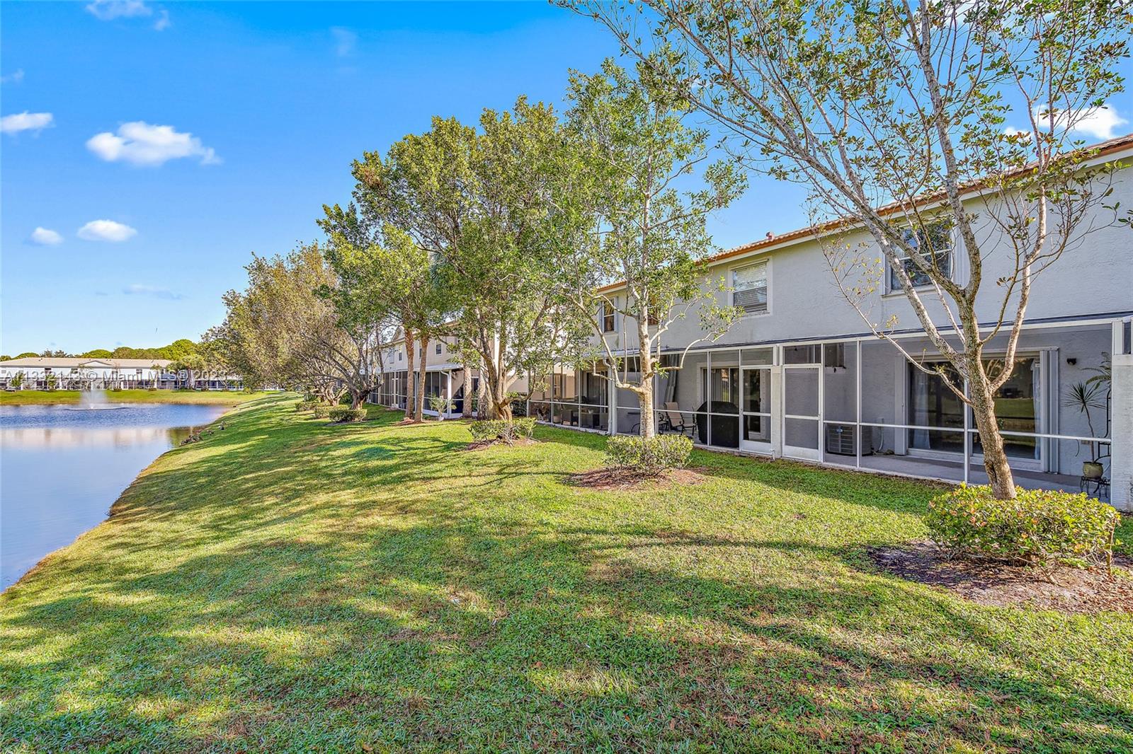 232 Timberwalk Trail Jupiter, FL 33458 - Photo 19 of 33 a view of a house with a big yard and palm trees