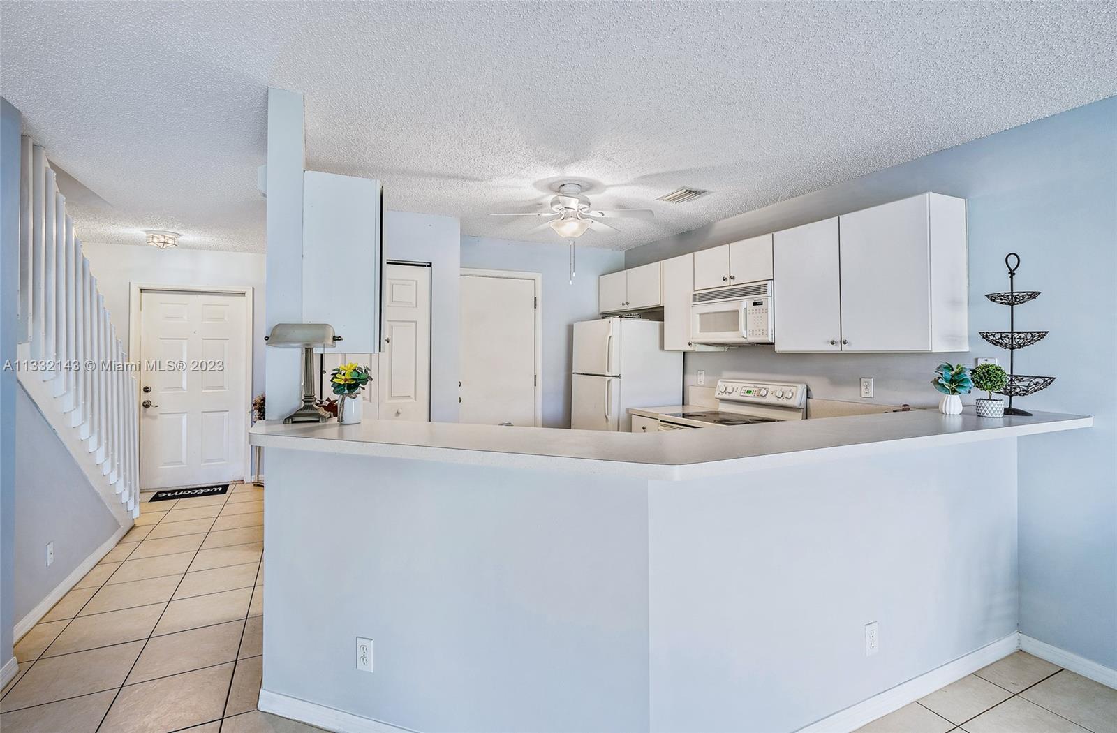 232 Timberwalk Trail Jupiter, FL 33458 - Photo 8 of 33 a kitchen with stainless steel appliances a sink a stove a refrigerator cabinets and a window