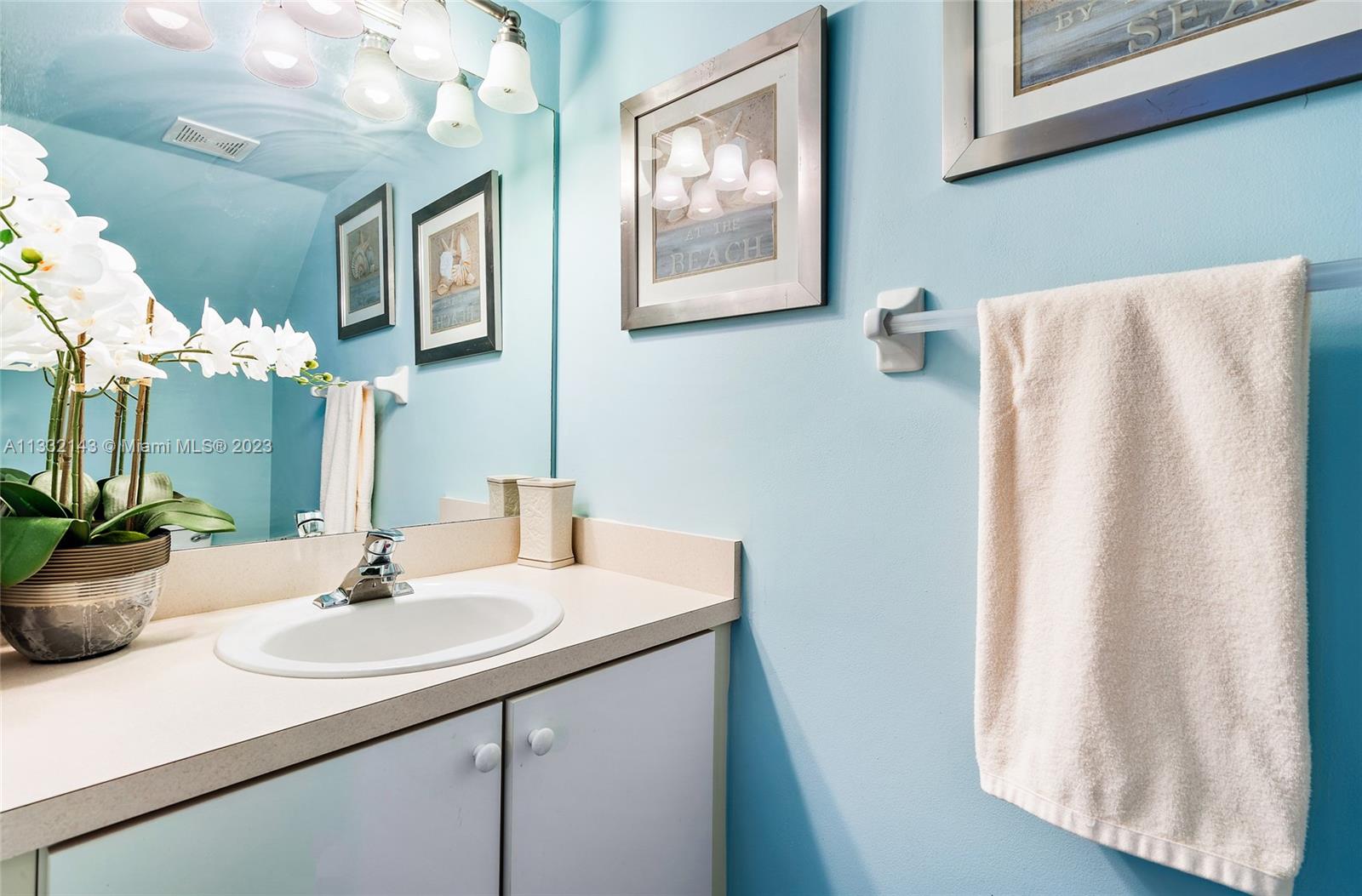 232 Timberwalk Trail Jupiter, FL 33458 - Photo 10 of 33 a bathroom with a sink and a mirror