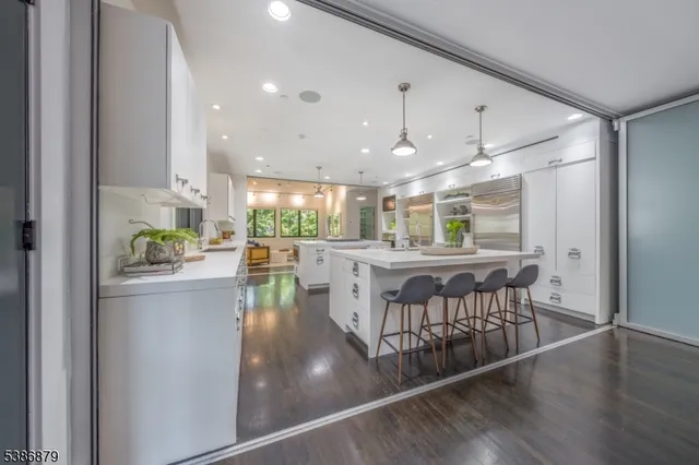 a kitchen with kitchen island a stove and a wooden floor