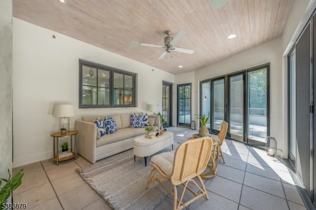 a living room with a large window and furniture