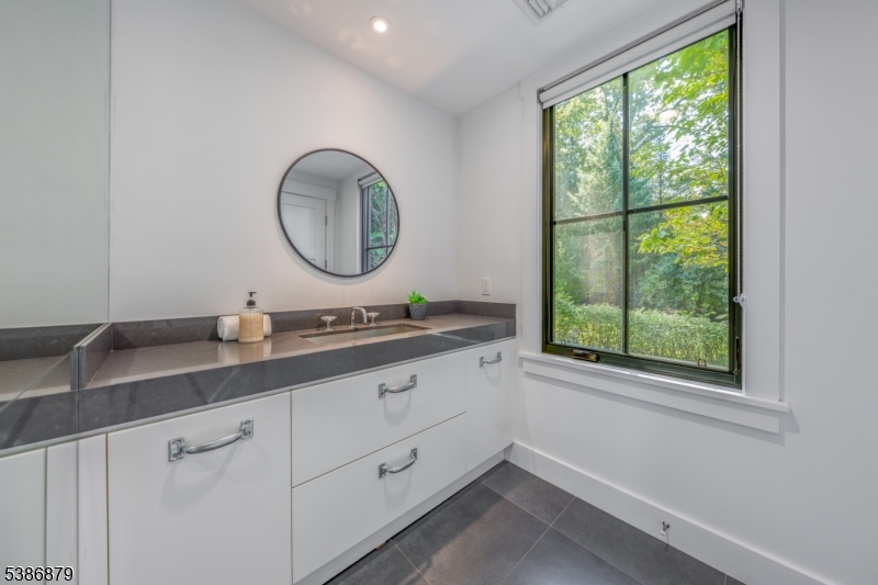 60 Fernwood Road Summit, NJ 07901 - Photo 27 of 50 a bathroom with a double vanity sink and a window