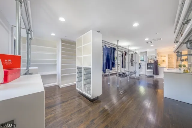 a view of a room with wooden floor and windows