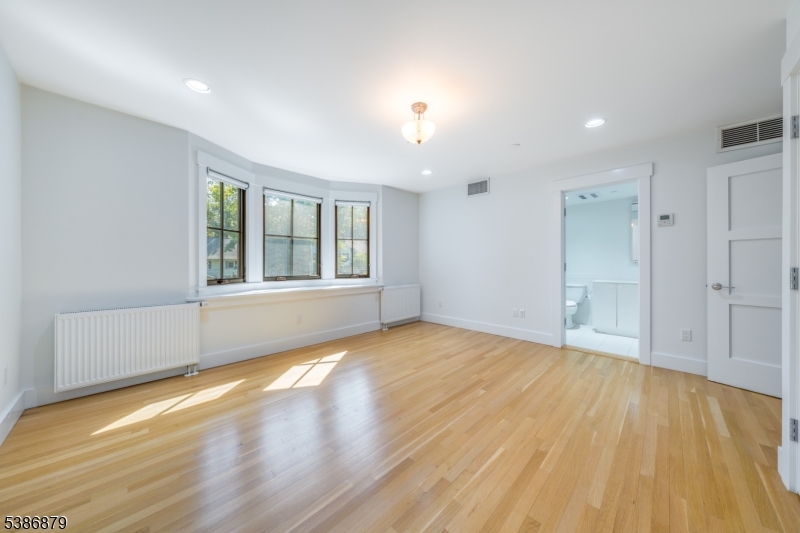 60 Fernwood Road Summit, NJ 07901 - Photo 32 of 50 a view of an empty room with wooden floor and a window