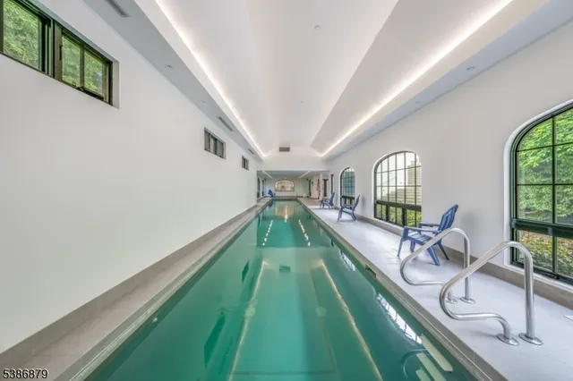 a living room with a floor to ceiling windows and a rug