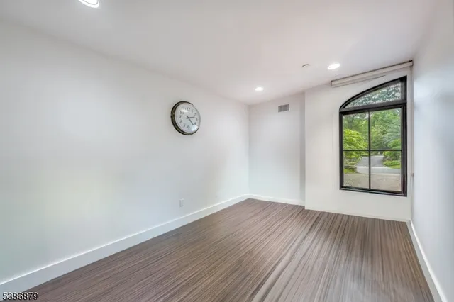 a view of a room with wooden floor and window