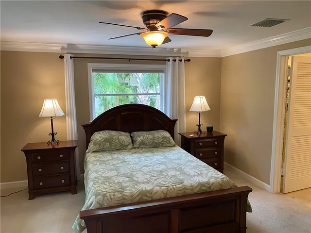 a bedroom with a bed and a lamp