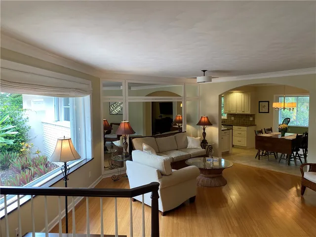 a living room with furniture a window and dining table