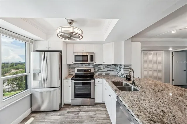 a kitchen with a sink stove and refrigerator