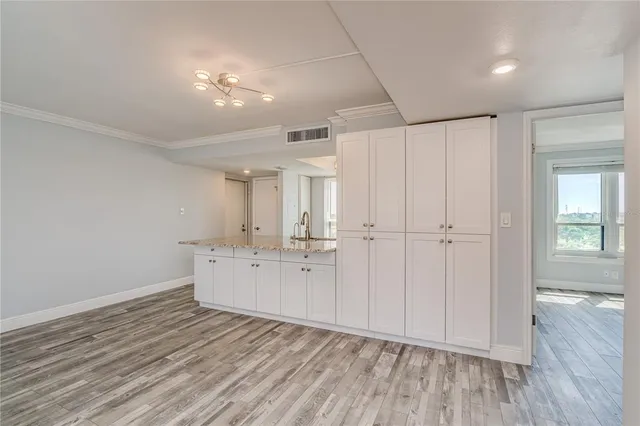 a view of a room with wooden floor