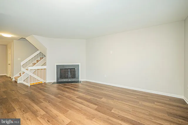 a kitchen with wooden floors and sink