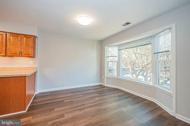 a view of a room with wooden floor and staircase