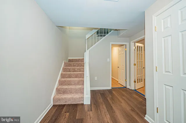 a view of a hallway with wooden floor and entryway