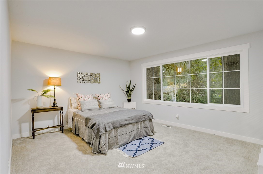 13534 Sherman Road Northwest Seattle, WA 98177 - Photo 13 of 20 a bedroom with a bed and a window