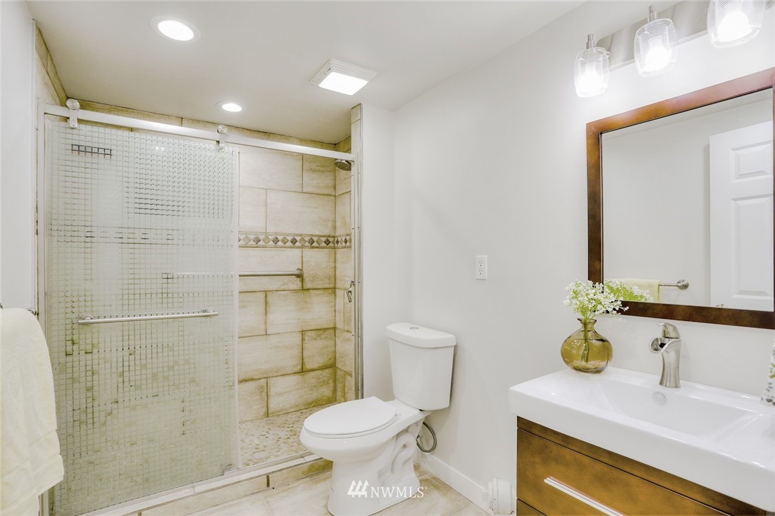 13534 Sherman Road Northwest Seattle, WA 98177 - Photo 18 of 20 a bathroom with a sink toilet and shower
