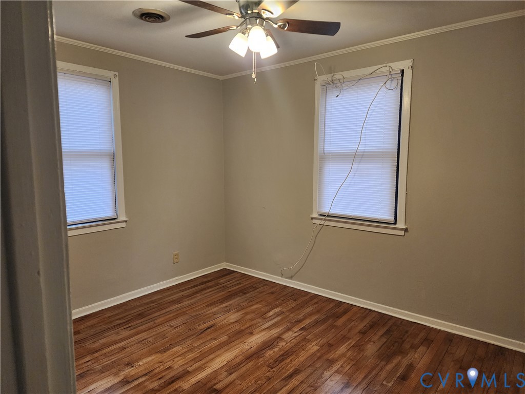 3005 Collins Road Richmond, VA 23223 - Photo 6 of 7 an empty room with wooden floor closet and windows