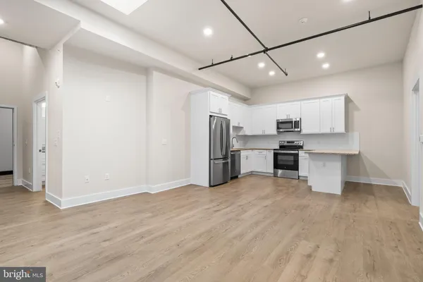 a view of kitchen with stainless steel appliances refrigerator oven