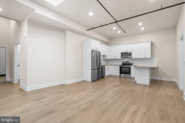 a view of kitchen with stainless steel appliances refrigerator oven