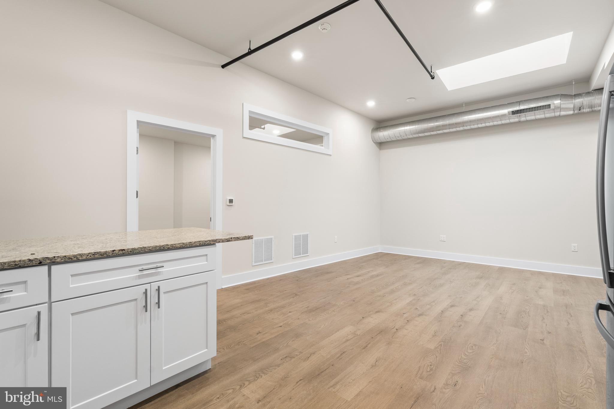 30 West Broad Street Souderton, PA 18964 - Photo 19 of 34 a view of a kitchen with white cabinets and wooden floor