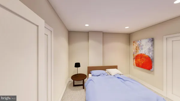 a bedroom with a bed and a painting on the wall