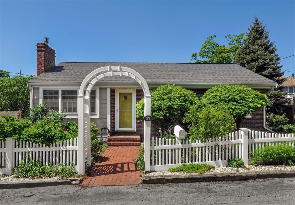 a front view of a house with a garden