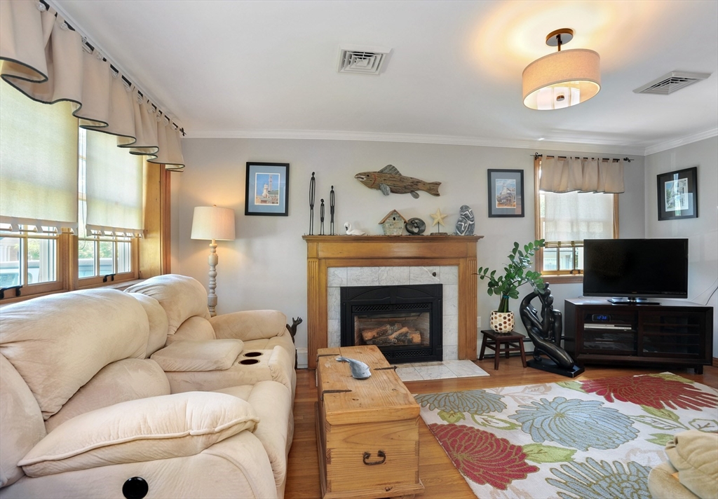 27 Atlantic House Road Hull, MA 02045 - Photo 12 of 30 a living room with furniture a flat screen tv and a fireplace