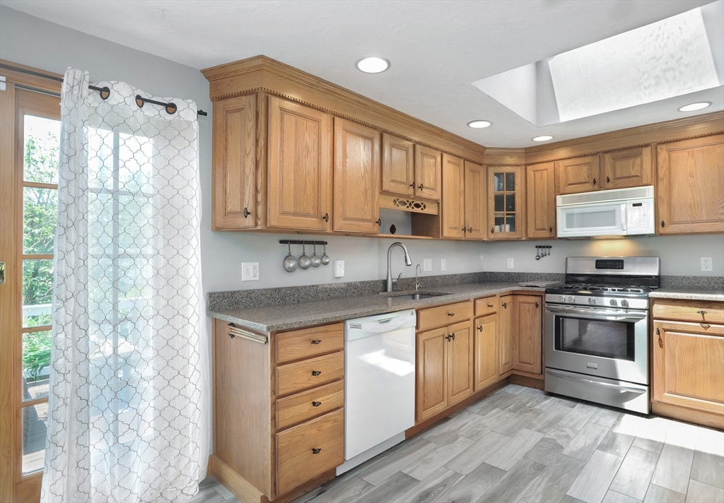 27 Atlantic House Road Hull, MA 02045 - Photo 15 of 30 a kitchen with stainless steel appliances granite countertop a stove a sink and a microwave