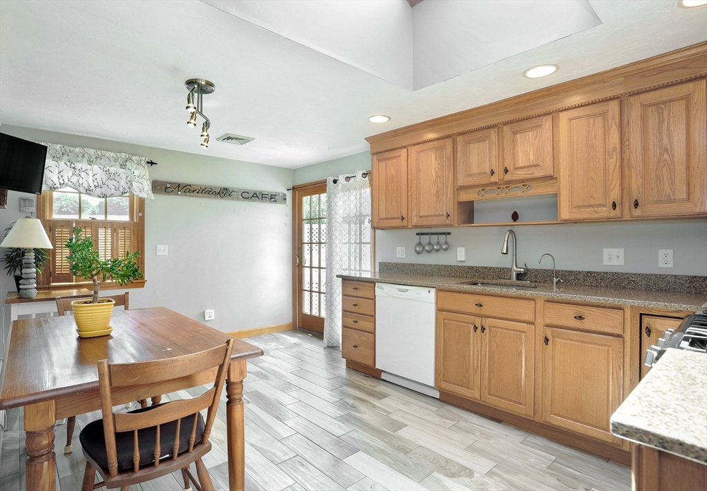 27 Atlantic House Road Hull, MA 02045 - Photo 16 of 30 a kitchen with a table chairs sink and cabinets