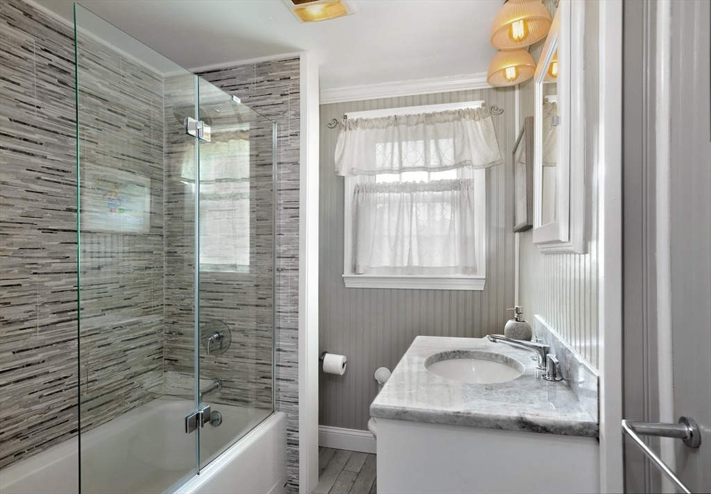 27 Atlantic House Road Hull, MA 02045 - Photo 17 of 30 a bathroom with a tub sink and mirror