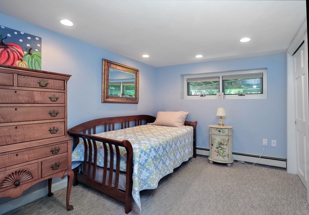 27 Atlantic House Road Hull, MA 02045 - Photo 21 of 30 a bedroom with a bed and a painting on the wall