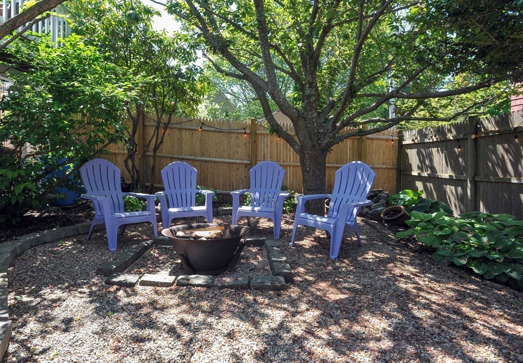 27 Atlantic House Road Hull, MA 02045 - Photo 6 of 30 a view of a backyard with chairs and a fire pit