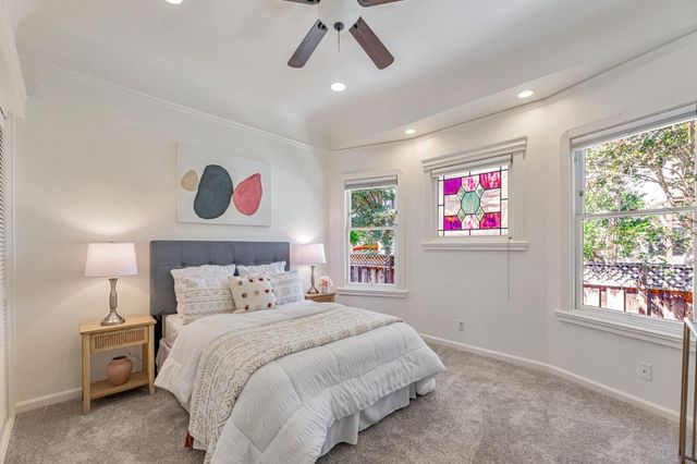 a bedroom with a bed and a large window