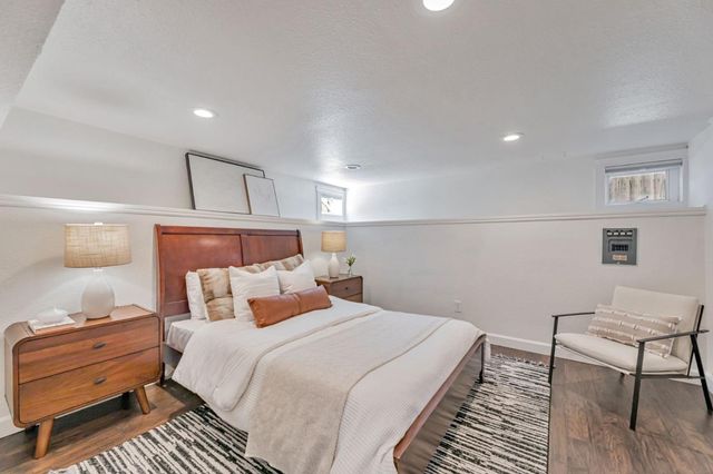 a bedroom with a bed and a chair