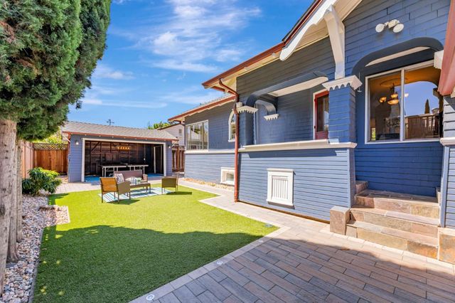 a view of a house with swimming pool and furniture