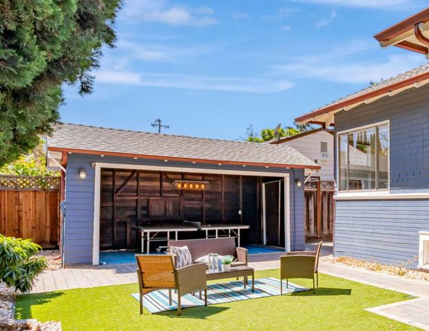 a view of a patio with couches table and chairs and potted plants