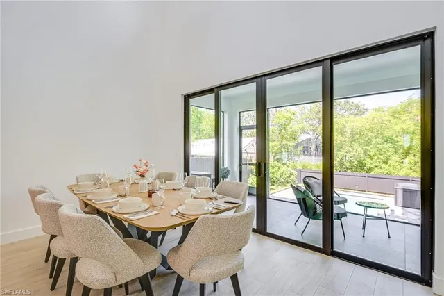 a view of a dining room with furniture and a potted plant
