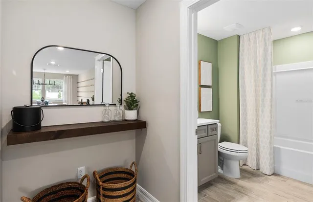 a bathroom with a toilet a sink and mirror